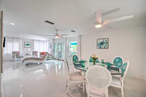 a dining room with a glass table and chairs at Waterfront Marco Island House with Shared Dock! in Marco Island