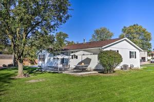 a white house with a yard at Warm and Cozy Buckeye Lake Home Yard and Patios! in Hebron