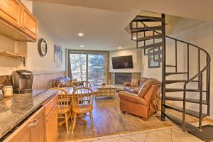 a kitchen with a spiral staircase and a living room at Copper Mountain Condo Near Ski Lift and Golf Course! in Copper Mountain