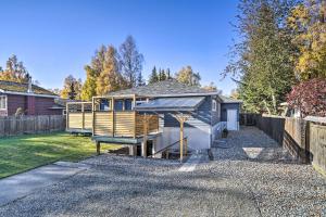 a house on a gravel driveway with a fence at Alluring Anchorage Apt - Walk to Coastal Trl! in Anchorage