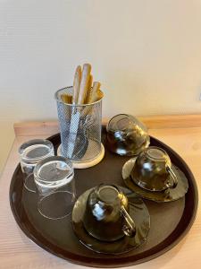 a tray with three tea pots and glasses on a table at Vladimirsky Dvorik Mini-Hotel in Vladimir