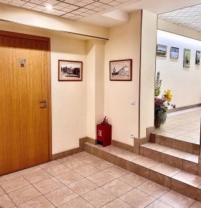 a hallway with a door and stairs in a building at Vladimirsky Dvorik Mini-Hotel in Vladimir