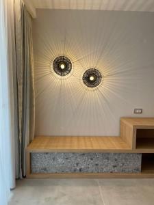 two mirrors on a wall with a wooden table at Alboro seaside suites in Parga