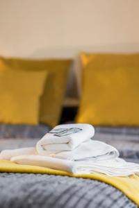 a pile of white towels sitting on top of a bed at Dunes Hotel in Whitley Bay