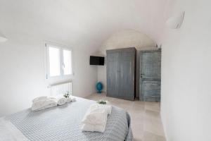 A bed or beds in a room at Trullo Lillo