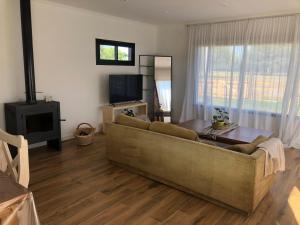 a living room with a couch and a table at Casa de campo DON ANTONIO in San Pedro
