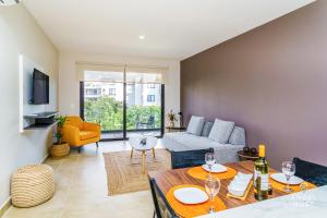 a living room with a table and a couch at Ciudad Mayakoba Homes by Vimex in Playa del Carmen