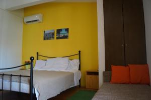 a bedroom with a bed and a yellow wall at Pirovac - most beautiful beaches in Dalmatia in Pirovac +35 photos