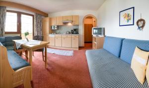 a living room with a couch and a table at Pension Grubenhof in Fulpmes +33 photos