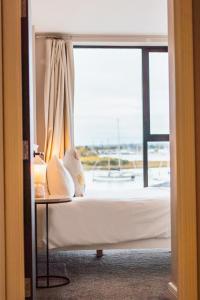 a bedroom with a bed and a large window at No Seven Harbour Side in Poole