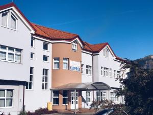 a row of white buildings with red roofs at Hotel Kupres in Kupres