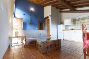 a living room with a couch and a table at Casas Arbillas in Arenas de San Pedro