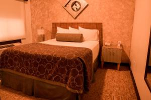 Postel nebo postele na pokoji v ubytování Business Hotel & Suites María Bonita