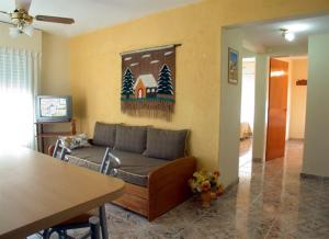 a living room with a couch and a table at BAHIA DEL LAGO in Villa Carlos Paz