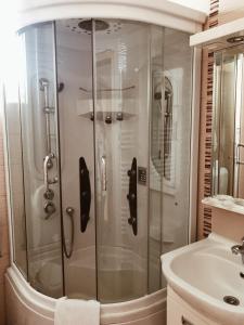 a bathroom with a shower and a sink at Hotel Kupres in Kupres