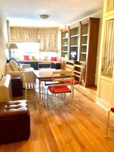 a living room with a table and chairs and a couch at Miramar Ski - your home away from home - in Sierra Nevada