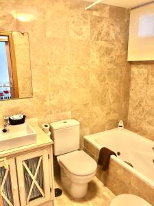 a bathroom with a toilet and a sink and a tub at Miramar Ski - your home away from home - in Sierra Nevada