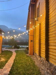 a string of lights on the side of a building at Villa "Затишна" in Mykulychyn