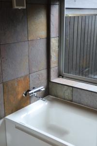 a sink in a bathroom with a window at villa YUUNOBI - Vacation STAY 78559v in Taragi