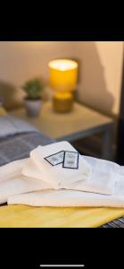 a pile of white towels sitting on top of a bed at Dunes Hotel in Whitley Bay