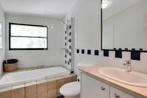 a bathroom with a tub and a sink and a toilet at Cylinder Cove Unit 5 in Point Lookout