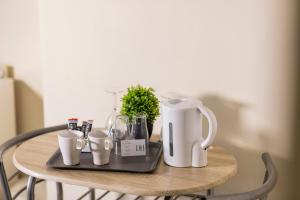 a table with a coffee maker and cups on it at Dunes Hotel in Whitley Bay