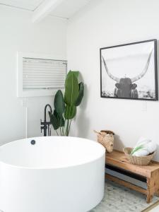 
a bathroom with a tub, sink, and mirror at Aqua by American Beech - Adults Only in Aquebogue
