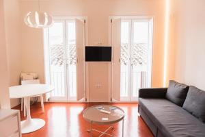 a living room with a couch and a table at Casa Rural Torrejón XV in Priego de Córdoba