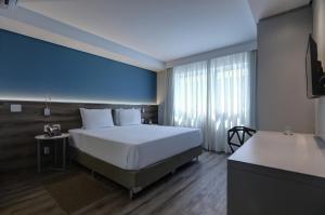 Ένα ή περισσότερα κρεβάτια σε δωμάτιο στο Comfort Hotel Guarulhos Aeroporto