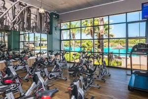 a gym with a bunch of bikes in a room at Crystal lagoon View 3Bed Apartment in Pretoria