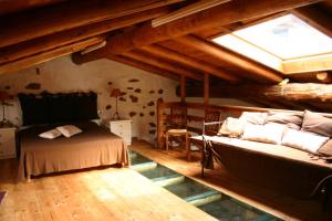 a attic bedroom with a bed and a window at Casa del Vasaio in Tenno