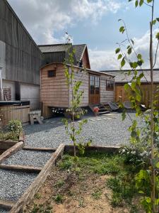 a backyard with a house and a gravel yard at The Shepherds Retreat - Luxury Glamping in Patrington
