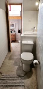 a bathroom with a toilet and a sink at Casa da Vila in Castelo de Vide