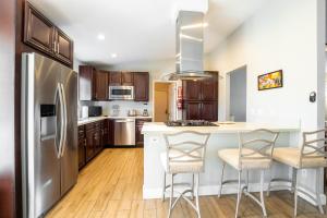 a kitchen with a stainless steel refrigerator and wooden cabinets at Beautiful Palm Springs Home large private yard in Palm Springs