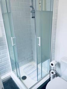 een badkamer met een glazen douche en een toilet bij Homely 3 Bed Town house in Coventry City Centre in Coventry