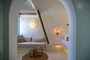 a living room with a couch and a table at SunSea Living Suites in Vourvoulos +72 photos