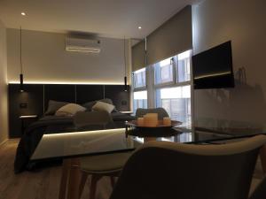 a living room with a bed and a glass table at Residencias Roque Suarez in Mar del Plata
