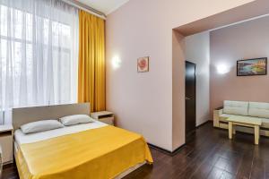 a hotel room with a bed and a window at Ostrovsky Hotel in Rostov on Don