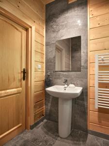 a bathroom with a white sink and a mirror at Pienińska Chata in Krościenko