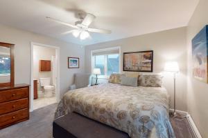 a bedroom with a bed and a ceiling fan at Mountain View at Mountainside in Stowe +68 photos