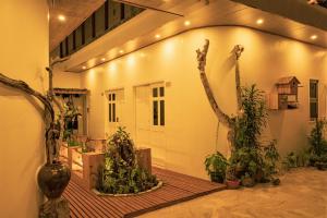 a courtyard with trees and plants in a building at Nala Island Village in Maafushi