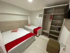 a small bedroom with two beds and a closet at Ancorar Flat Porto de Galinhas-Flat 3311-3314 in Porto De Galinhas +41 photos