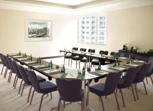 a conference room with a long table and chairs at Radisson Blu Residence, Dubai Marina in Dubai +61 photos