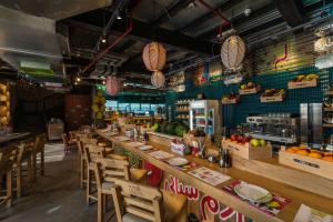 a restaurant with a long bar with wooden chairs at Radisson Blu Residence, Dubai Marina in Dubai