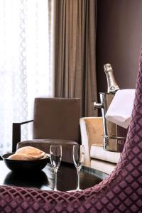 a table with two wine glasses and a bottle of champagne at Radisson Blu Mammy Yoko Hotel in Freetown +142 photos