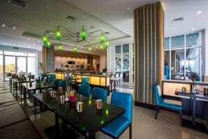 a restaurant with tables and chairs and a bar at Park Inn by Radisson, Kigali in Kigali