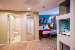 a hotel room with a bed and a mirror at Park Inn by Radisson, Kigali in Kigali