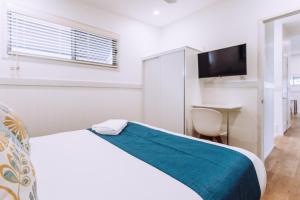 Postel nebo postele na pokoji v ubytování Woolgoolga Beach Holiday Park