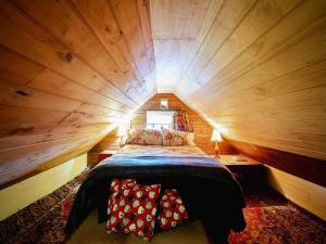 a bedroom with a bed in a tree house at Portobello Settler's Cottage in Portobello