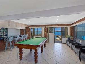 a living room with a pool table in a house at Toukley Waterfront House in Toukley